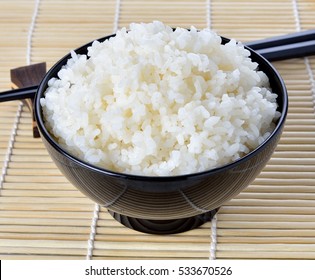 White Steamed Rice In Black Round Bowl