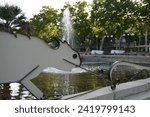 White steel lizard in fountain of Barcelona, Spain, unique iron statue in the park