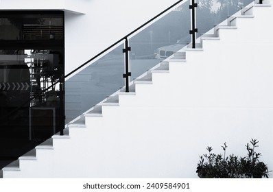 White steps with glass railing. Stone staircase in residential house, building of construction industry. Concrete steps. View of concrete steps and railing leading to an entrance in a modern building - Powered by Shutterstock