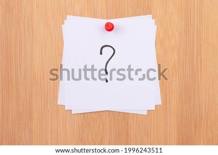 White Sticky Notes with Question Mark Pinned to the Wooden Message Board. To Do List Reminder in the Office. Memo Note at Work