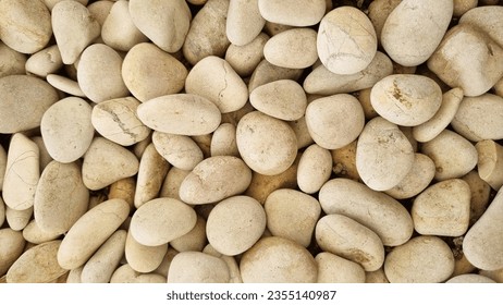 White stone background (texture). Pile of white stones forming an abstract pattern. Used as background or copyscape.