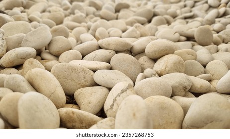 White stone background (texture). Pile of white stones forming an abstract pattern. Used as background or copyscape.
