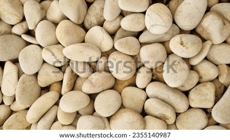 White stone background (texture). Pile of white stones forming an abstract pattern. Used as background or copyscape.