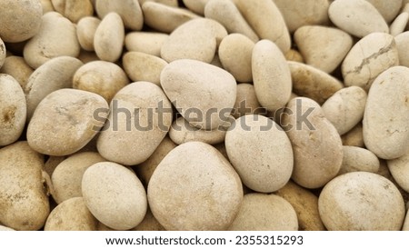 White stone background (texture). Pile of white stones forming an abstract pattern. Used as background or copyscape.