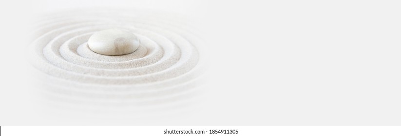 White stone in the sand. Zen japanese garden background scene. Horizontal banner
