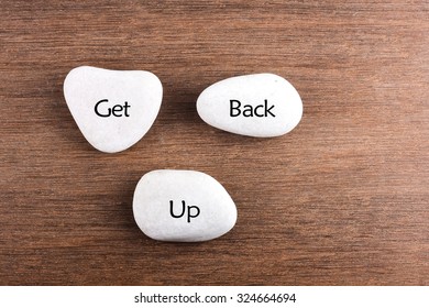 White Stones With Get Back Up Word On Wooden Background