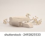 White Stones platform podium, dry flower twig on beige light background. Minimal empty display product presentation scene.