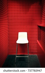 White Stool In A Red Cabin With Foam Soundproof Panels