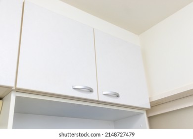 White Storage Shelves Near The Ceiling