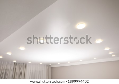 White stretch ceiling with spot lights in room