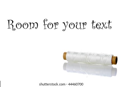 white string on a spool isolated on white with reflections and room for your text