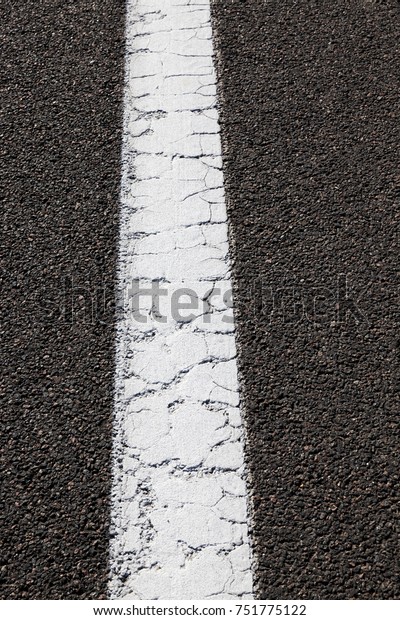 white strip of road markings on a new road,\
close-up photo