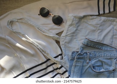 White Striped Cardigan, Vintage Mom Jeans, White Linen Tote Bag And Round Sunglasses. Flat Lay.