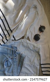 White Striped Cardigan, Vintage Mom Jeans, White Linen Tote Bag And Round Sunglasses. Flat Lay.