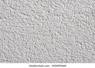 White structural facade plaster. Acrylic plaster structure. Lamb style plaster with small granules