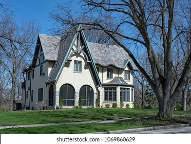 White Stucco Gothic Revival House With Blue Accents