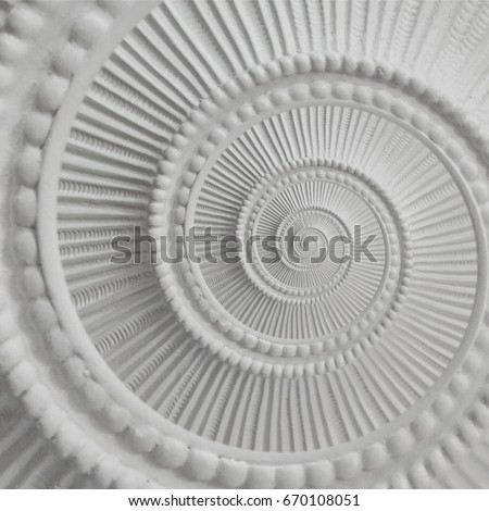 White stucco moulding plasterwork spiral abstract fractal pattern background. Plaster abstract spiral effect background. White gypsum spiral abstract background. Decorative stucco element fractal