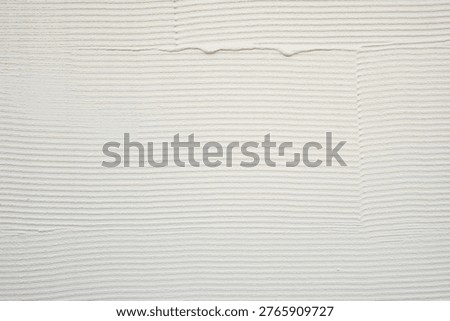 White stucco-style earthen wall texture with a combed finish, rough architectural background material.