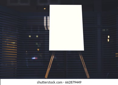 White stylish chalkboard with mock up copy space are for your text message or advertising promotional content, empty presentation wooden board standing on the glass storefront