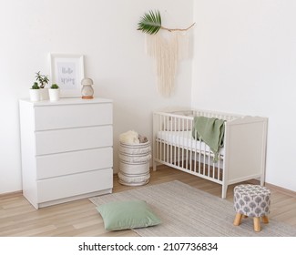 White stylish modern scandi baby's room interior with baby bed and chest of drawers. Children's room interior decor in white and green colors. - Shutterstock ID 2107736834