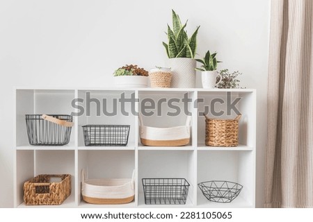 White stylish shelf in scandi style. Storage baskets. Japanese method organizer boxes set. Closet organizing concept. copy space