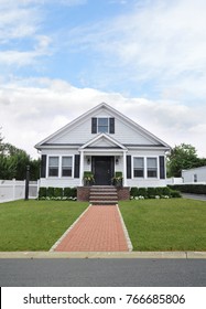 White Suburban Bungalow Home Brick Walkway Blue Sky USA