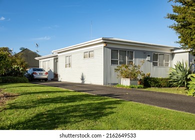 White suburban house with flat roof. Auckland, New Zealand - May 20, 2022