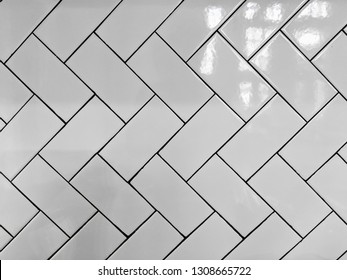 White Subway Tile Wall In Herringbone Pattern