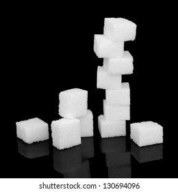 White Sugar Cubes Over Black Background.