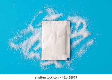 White Sugar Packets on a Blue background.