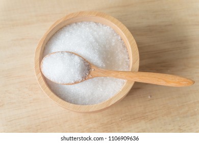 White Sugar In Wood Bowl And Spoon On Wood Background.