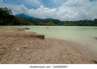 White Sulfur Water Lagoon Surrounded By Trees