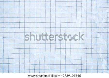 A white surface with a fine blue grid pattern, showing slight texture.