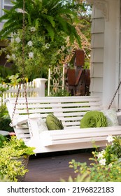 White Swing On Charming Front Porch Setting On A Victorian Home.  Selective Shallow Depth Of Field. 