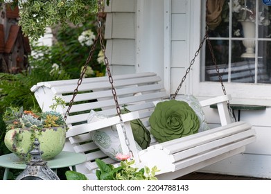 White Swing On Charming Front Porch Setting On A Victorian Home.  Selective Shallow Depth Of Field. 