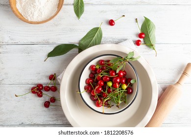 White table with baking dish and cherry