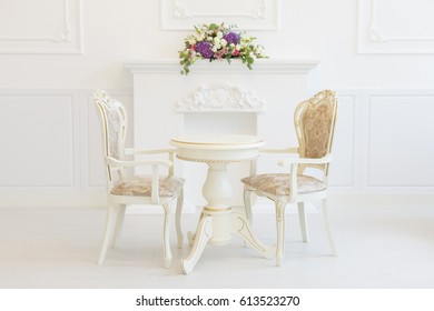 White Table And Chair In A Living Room. Modern Classics With Rococo Elements