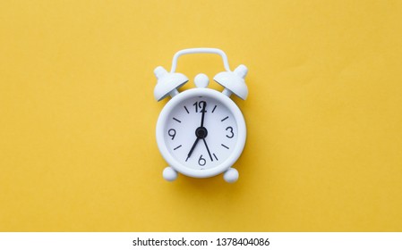 White Table Clock, Alarm On Yellow Background, Top View. Good Morning. Minimalism, Flatlay