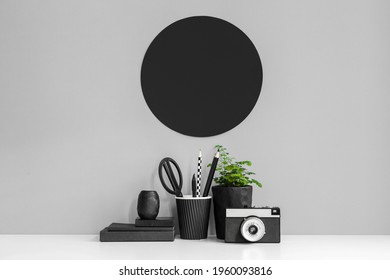 White table with office objects and grey wall. Mock up.
