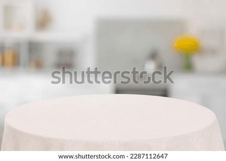 White tablecloth on table in kitchen. Space for design