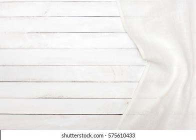 White Tablecloth On A White Wooden Kitchen Table. View From Above With Copy Space.