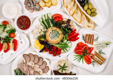 White tablecloth, surrounded by snacks. Variety of dishes. Kitchen, menu, concept of food