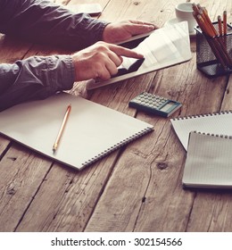 White Tablet Computer In Men Hands. Concept Man Working From Home Using Tablet Computer Or Working Outside The Office. Free Space For Text. Top View. Copy Space. Square Frame