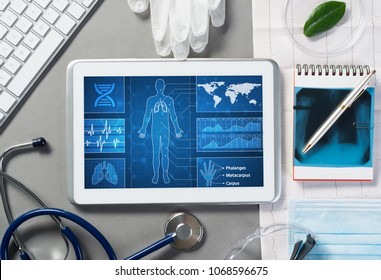 White Tablet Pc And Doctor Tools On Gray Surface