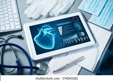 White tablet pc and doctor tools on gray surface - Shutterstock ID 574043182