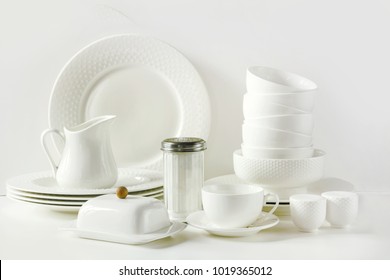 White tableware for serving. Crockery,dish, utensils and other different white stuff on white table-top. Kitchen still life. Copy space. - Shutterstock ID 1019365012