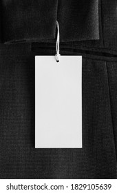 White Tag Mockup On A Black Suit.