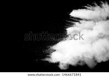 White talcume powder explosion on black background. White dust particles splash.