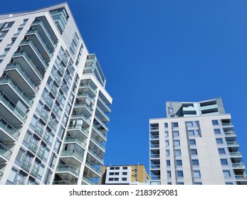 White tall apartment buildings against the blue sky - Shutterstock ID 2183929081