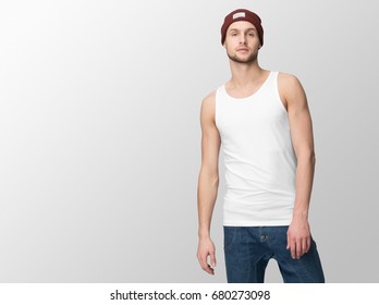 White Tank Top On A Young Man In Jeans And Hat, Isolated With Copy Space, Mockup.